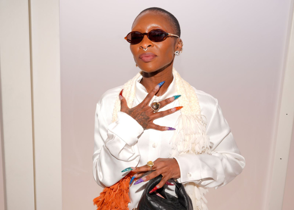 Cynthia Erivo wears a white top and sports a long French manicure with multicolored textured croc tips.