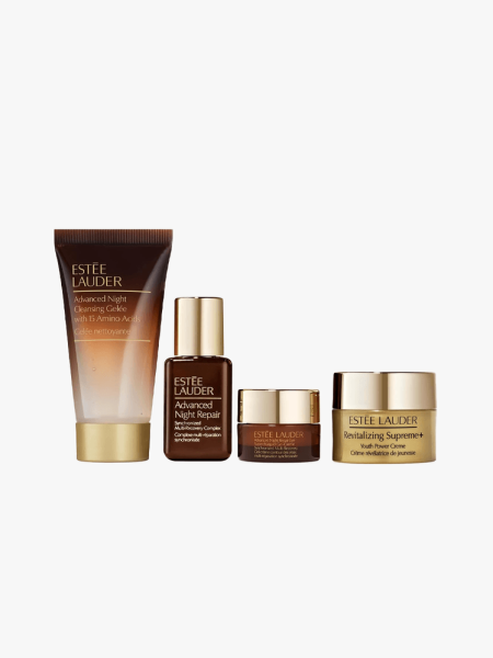 Estée Lauder The Glow Heroes in multiple branded components on a light gray background