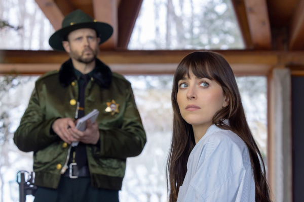 Dakota Johnson stars as Lowen Ashleigh in director Michael Showalter's VERITY. In this still she sits on a couch in a...